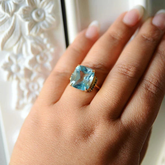 Isabella Blue Topaz ring with blue diamond studded hinges on the sides